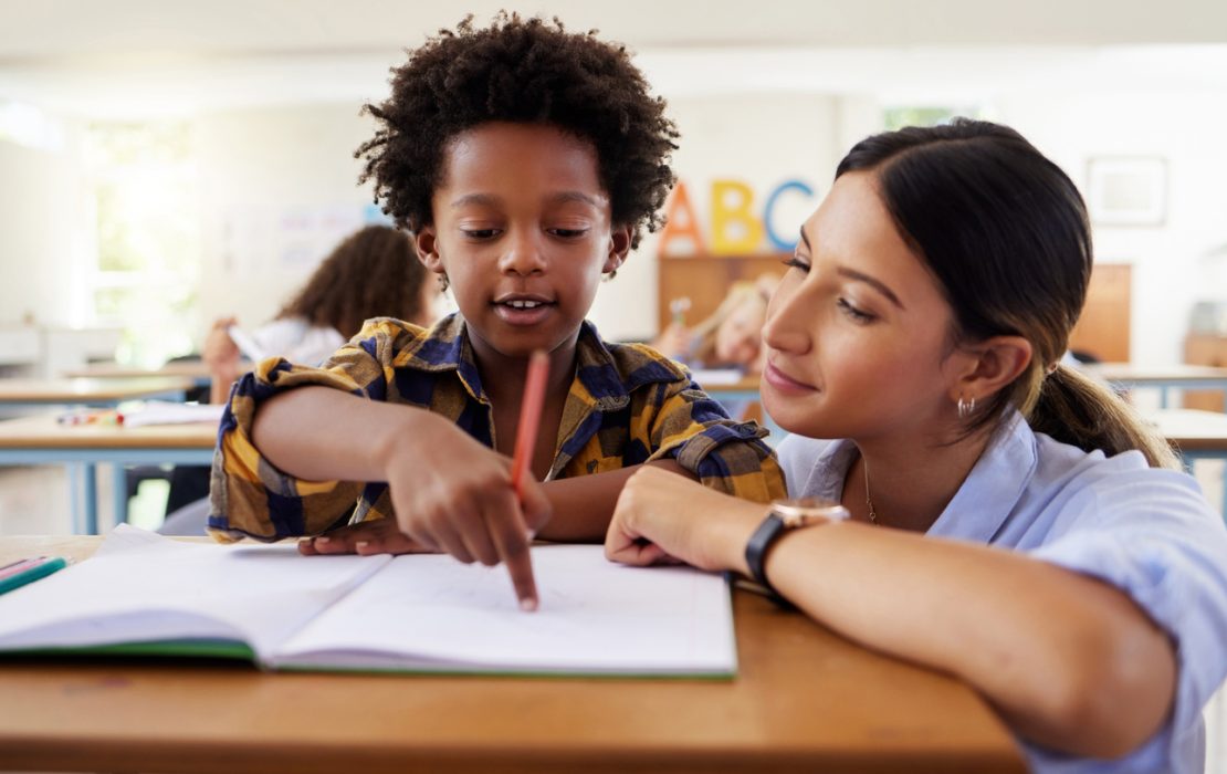 Tutor with student who has a learning disability, showing a multisensory teaching method