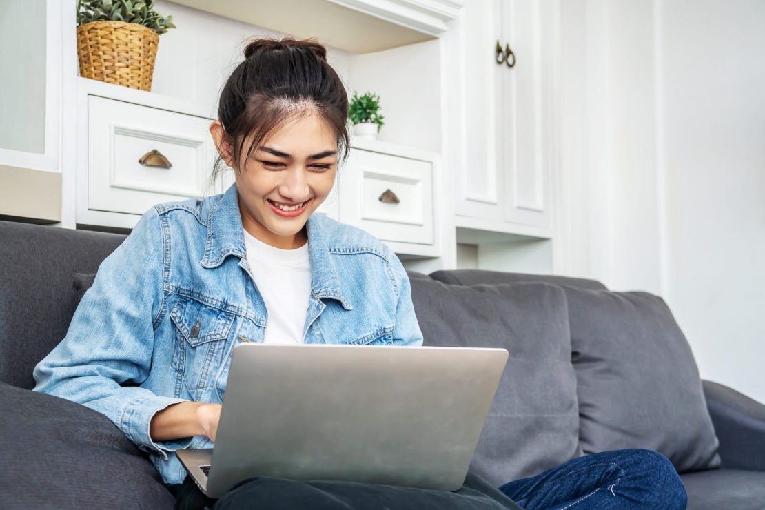 Young college applicant with learning disabilities smiling while filling out a college application
