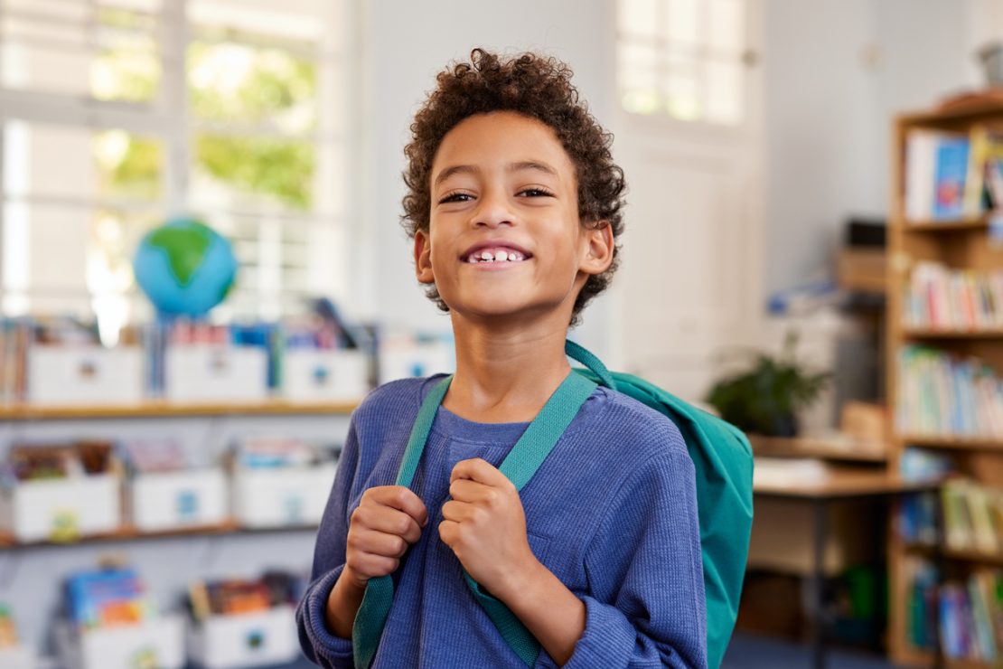 Boy with backpack is smiling