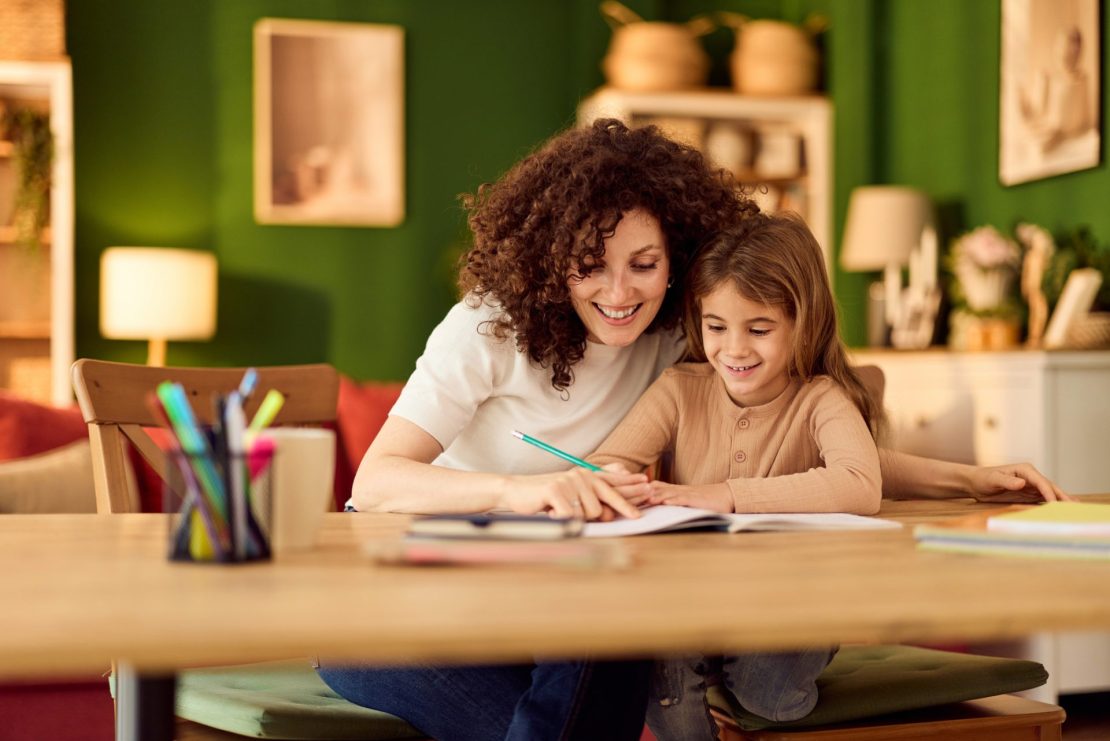 A parent and child working together at a homework table with visual timers and minimal distractions, illustrating strategies to help an ADHD child stay on task.
