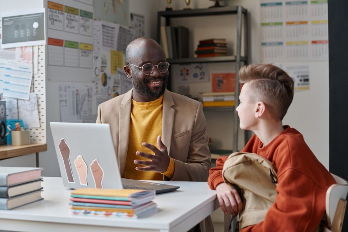 A tutor working one-on-one with a student using visual organizers and hands-on materials during a summer session, illustrating ADHD tutoring support.