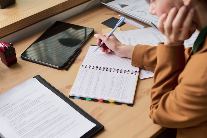 A student with ADHD using a planner and organized school materials while preparing homework, illustrating back-to-school strategies for organization, focus, and executive functioning.